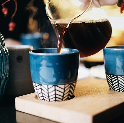 A cup being filled with freshly brewed, nutritious coffee